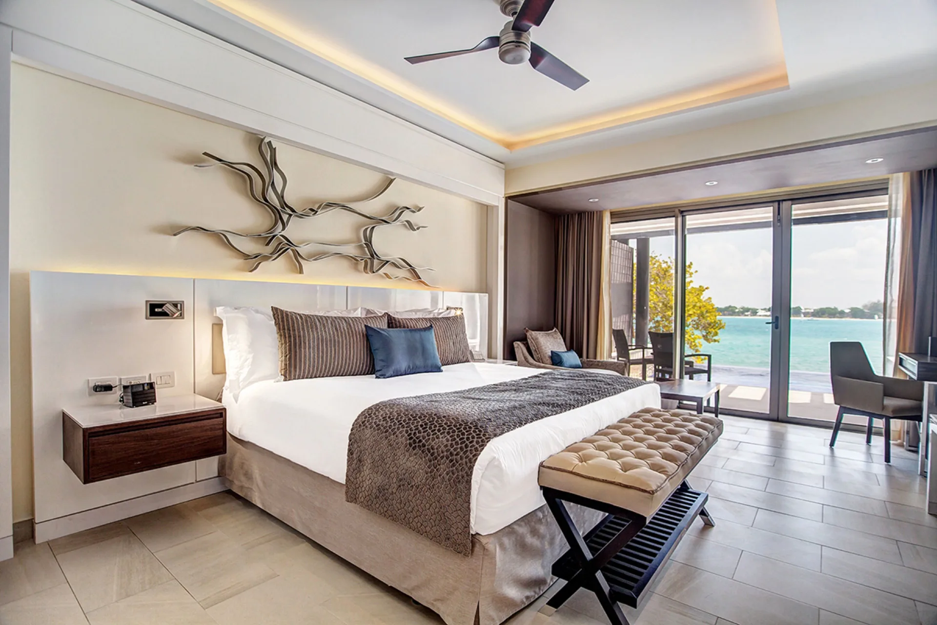 Sunset Ocean View Suite king bed and balcony at Grand Lido Negril Au-Naturel.