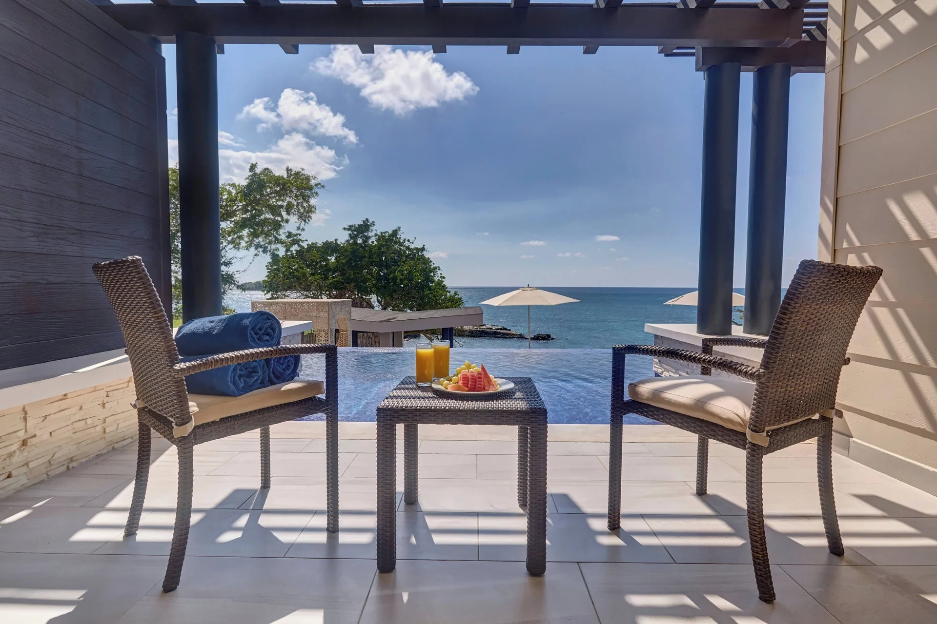 Sunset Swim Out Suite terrace with chairs and ocean view at Grand Lido Negril Au-Naturel.