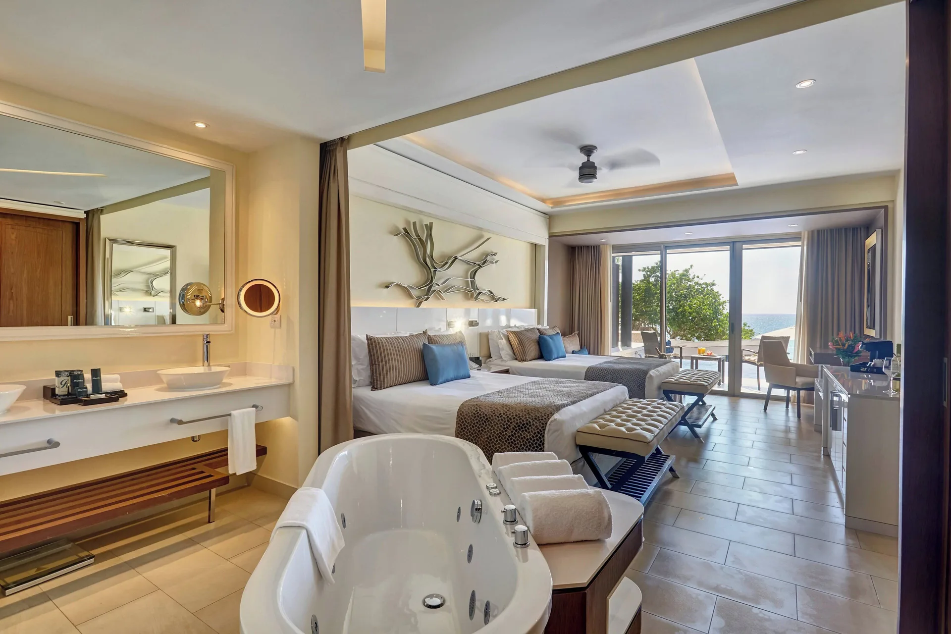 Sunset Swim Out Suite with two beds, vanity, tub, and ocean view at Grand Lido Negril Au-Naturel.