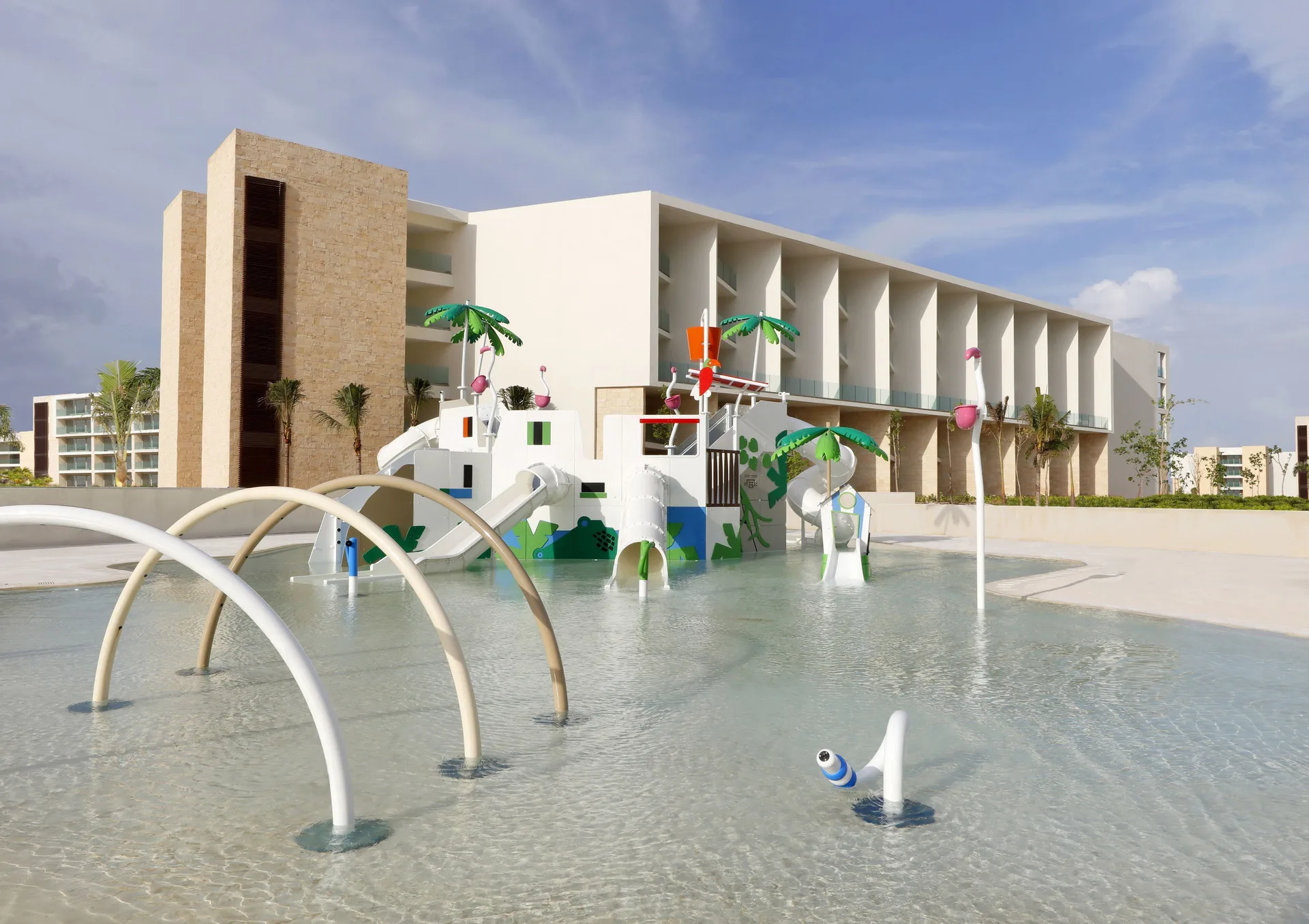 Kids' splash pool with slides and spray features at Grand Palladium Select Costa Mujeres.