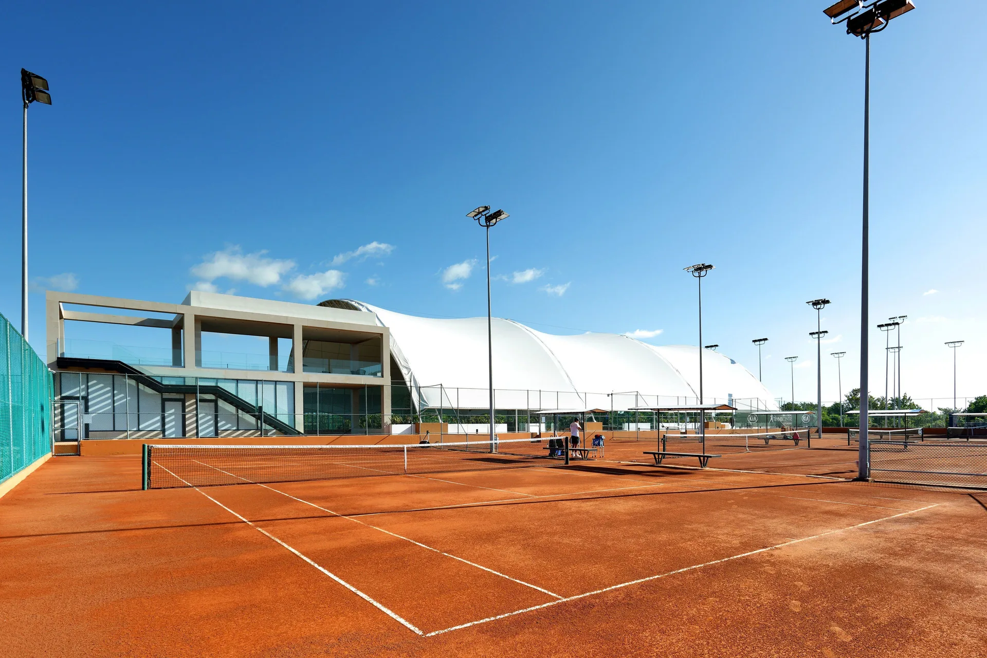 Outdoor clay tennis courts at Grand Palladium Select Costa Mujeres.