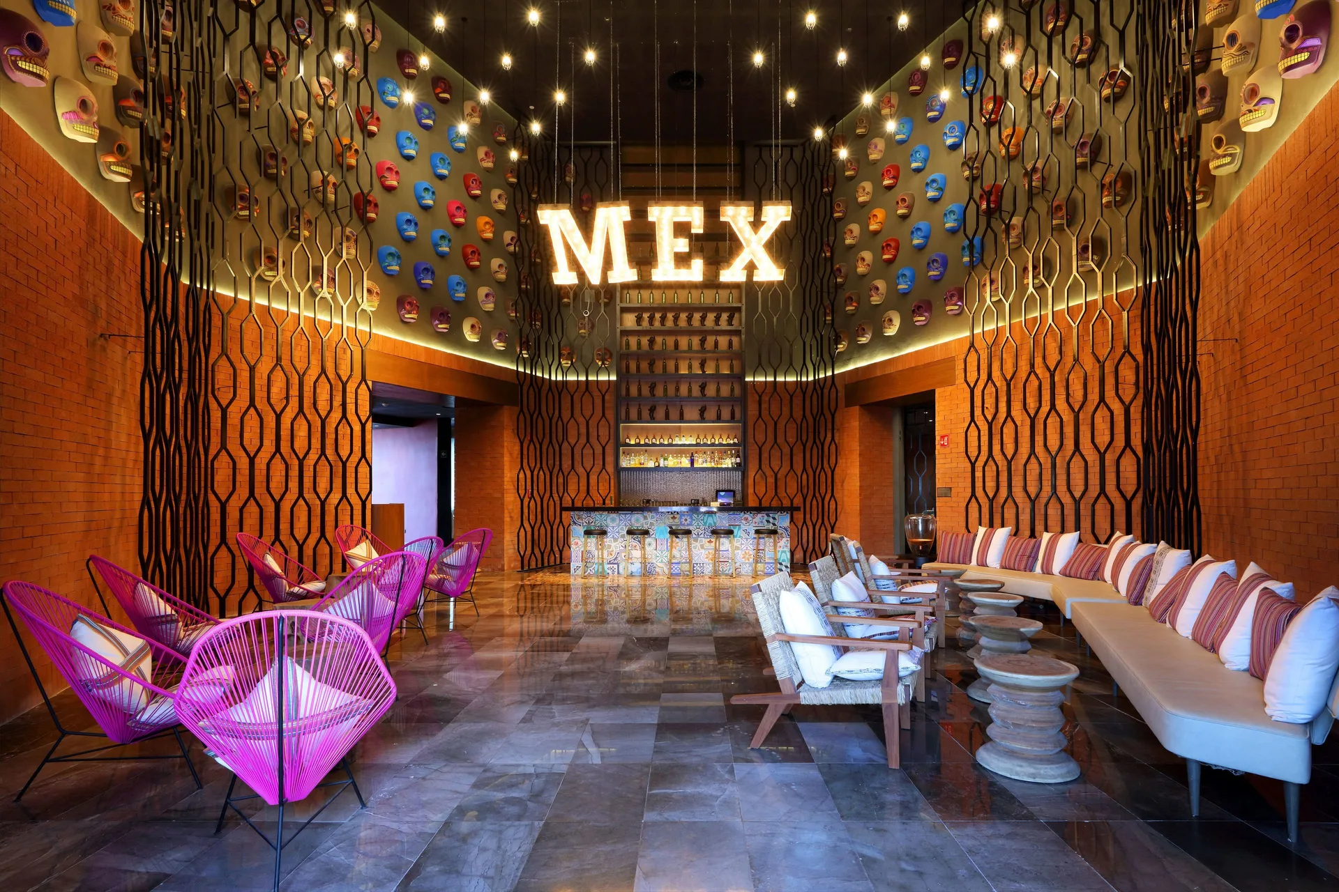 Mexican-themed lounge with skull wall decor and bar at Grand Palladium Select Costa Mujeres.
