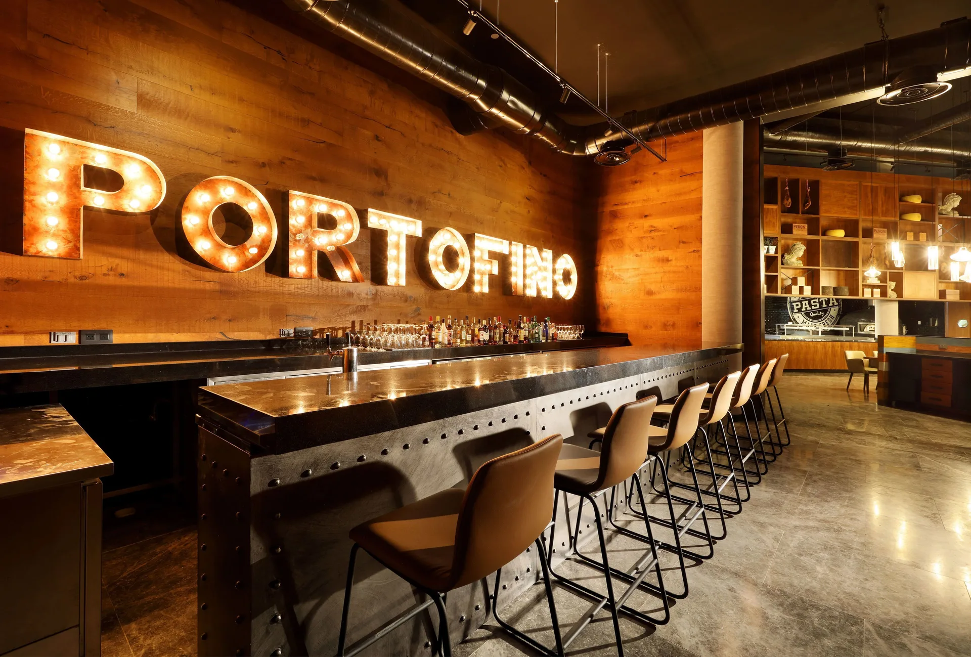 Portofino bar with illuminated wall sign at Grand Palladium Select Costa Mujeres.
