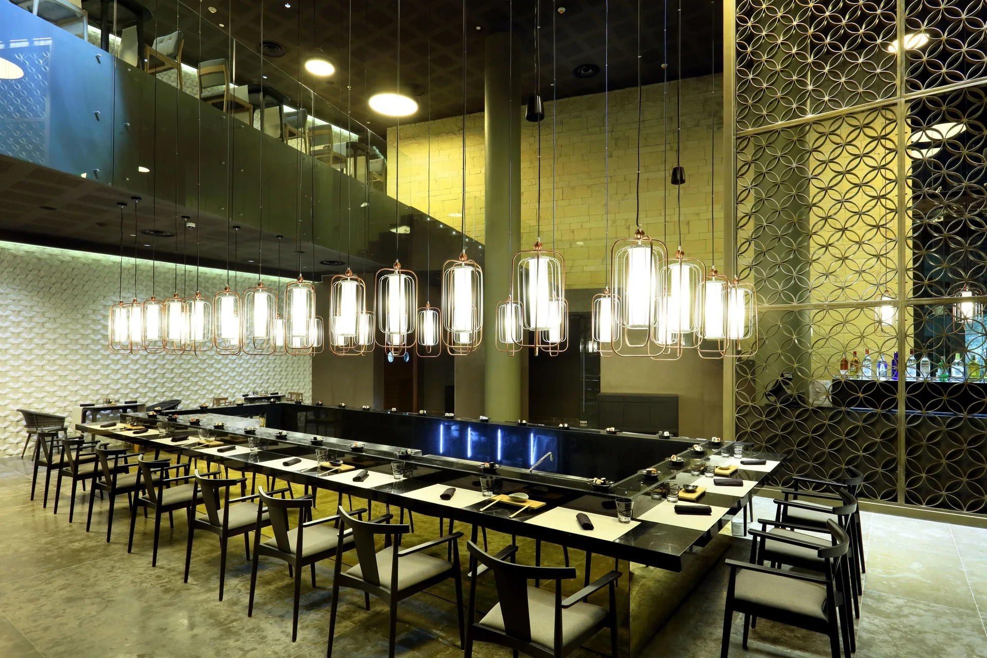 Japanese teppanyaki tables with hanging lanterns at Grand Palladium Select Costa Mujeres.