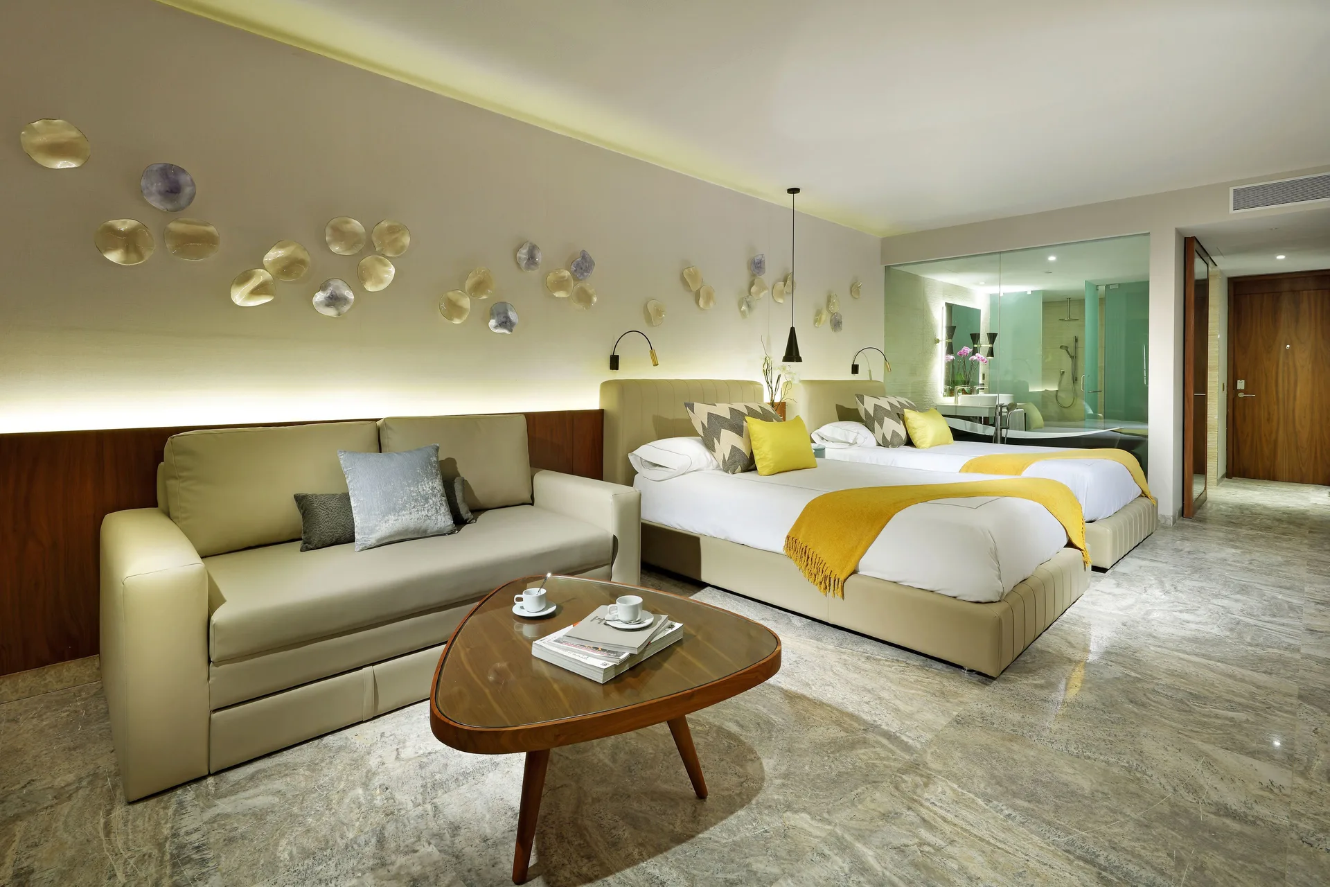 Junior Suite with two beds, sofa, and open bath at Grand Palladium Select Costa Mujeres.