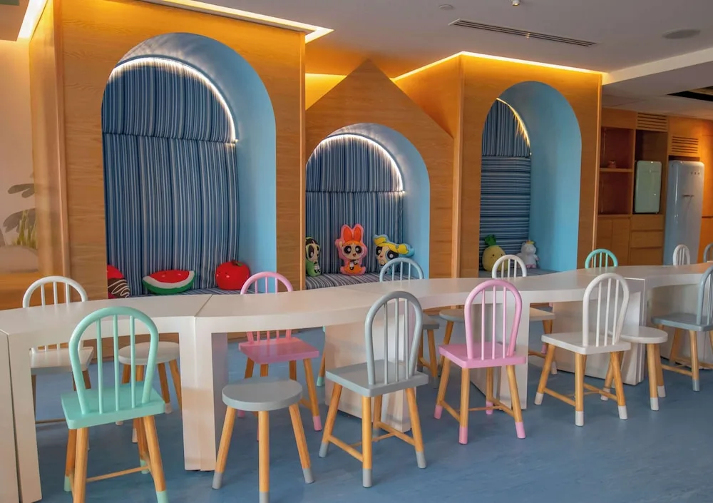 Children's activity room at Grand Velas Los Cabos with pastel chairs and arched seating nooks.