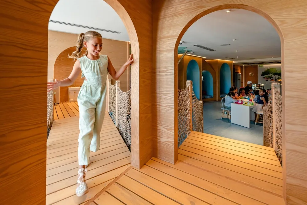 Children’s play area with wooden arches and a bridge at Grand Velas Los Cabos.