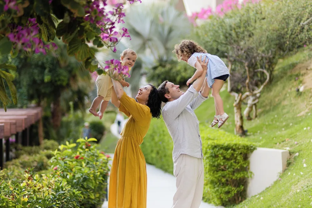 Family playing on a landscaped garden path at Grand Velas Los Cabos.