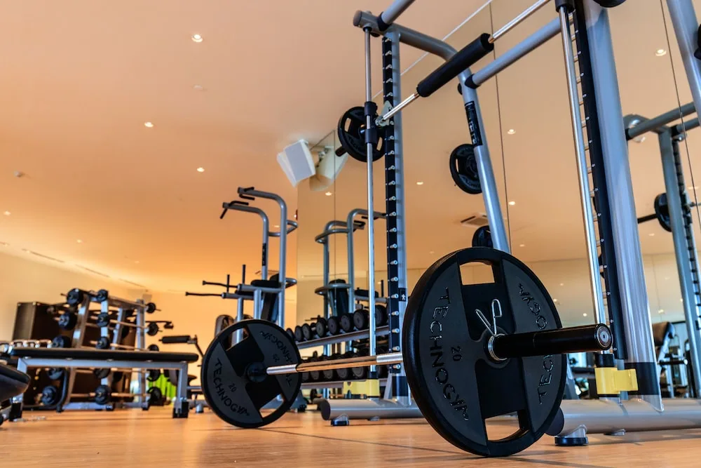 Weight bar and strength-training equipment in the fitness center at Grand Velas Los Cabos.