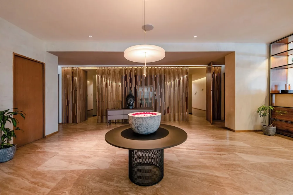 Spa entrance with a flower-filled bowl and wood screen at Grand Velas Los Cabos.