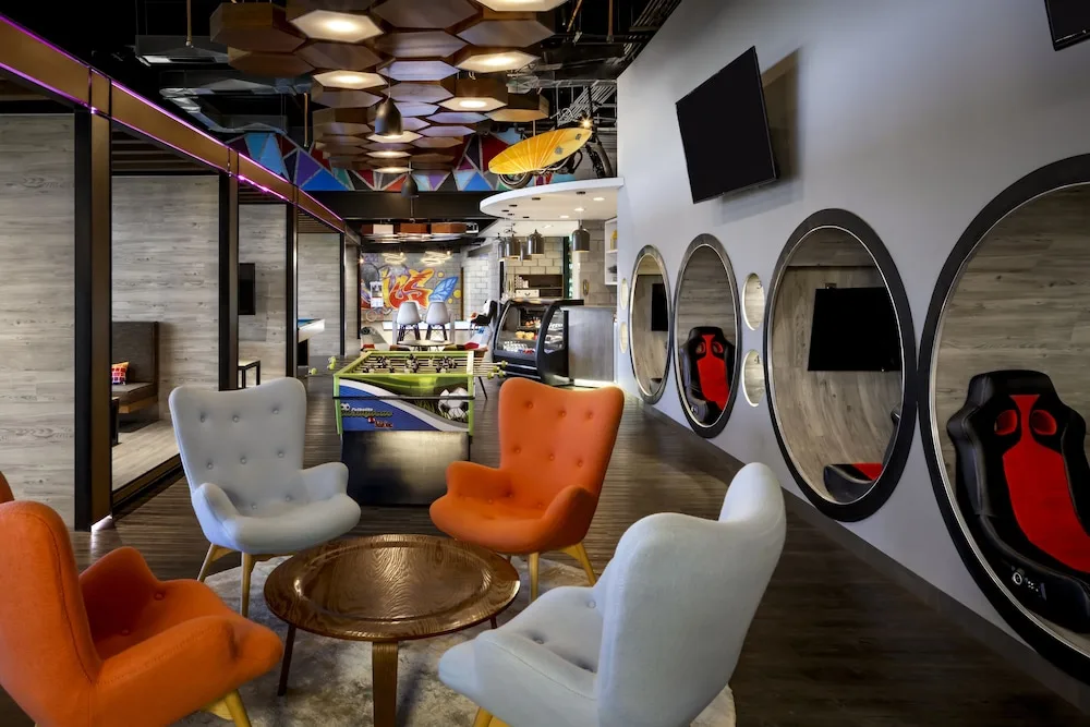 Teen lounge seating, gaming pods, and foosball table at Grand Velas Los Cabos.