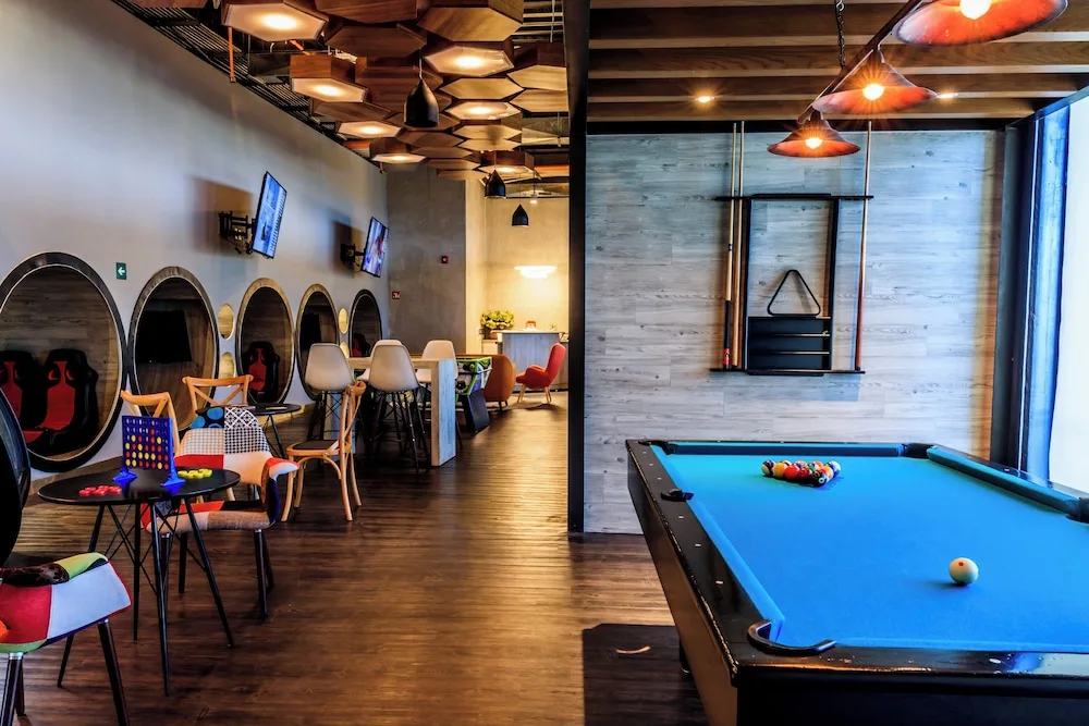 Pool table with lounge seating and games in a teen room at Grand Velas Los Cabos.