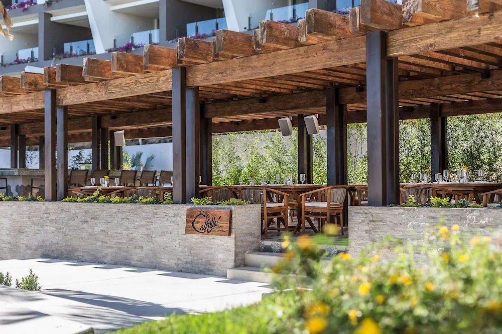 Cabrilla outdoor dining terrace with wood pergola at Grand Velas Los Cabos.
