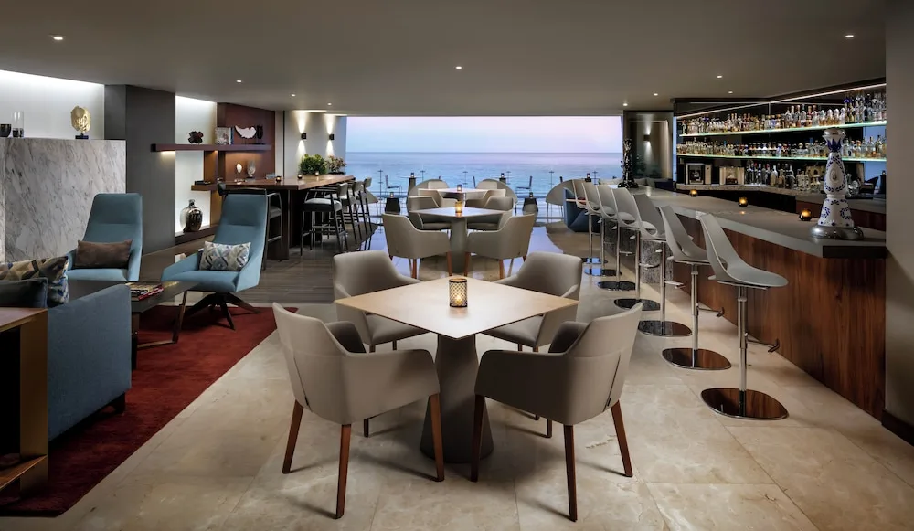 Modern indoor bar and lounge with ocean views at Grand Velas Los Cabos.