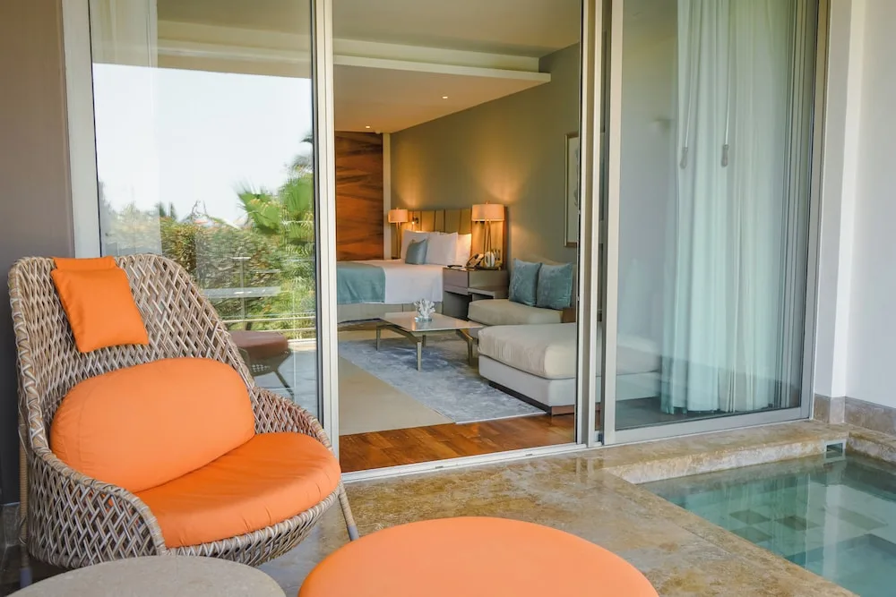 Ambassador Pool Suite terrace and king bed at Grand Velas Los Cabos.
