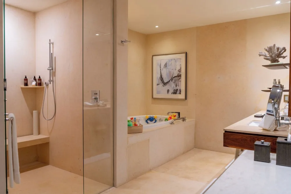 Family Duplex bathroom with shower, tub, and double vanity at Grand Velas Los Cabos.