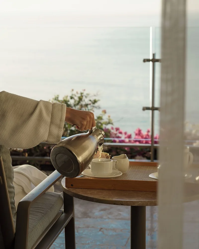 Tea being poured on the Grand Class Corner Suite terrace at Grand Velas Los Cabos.