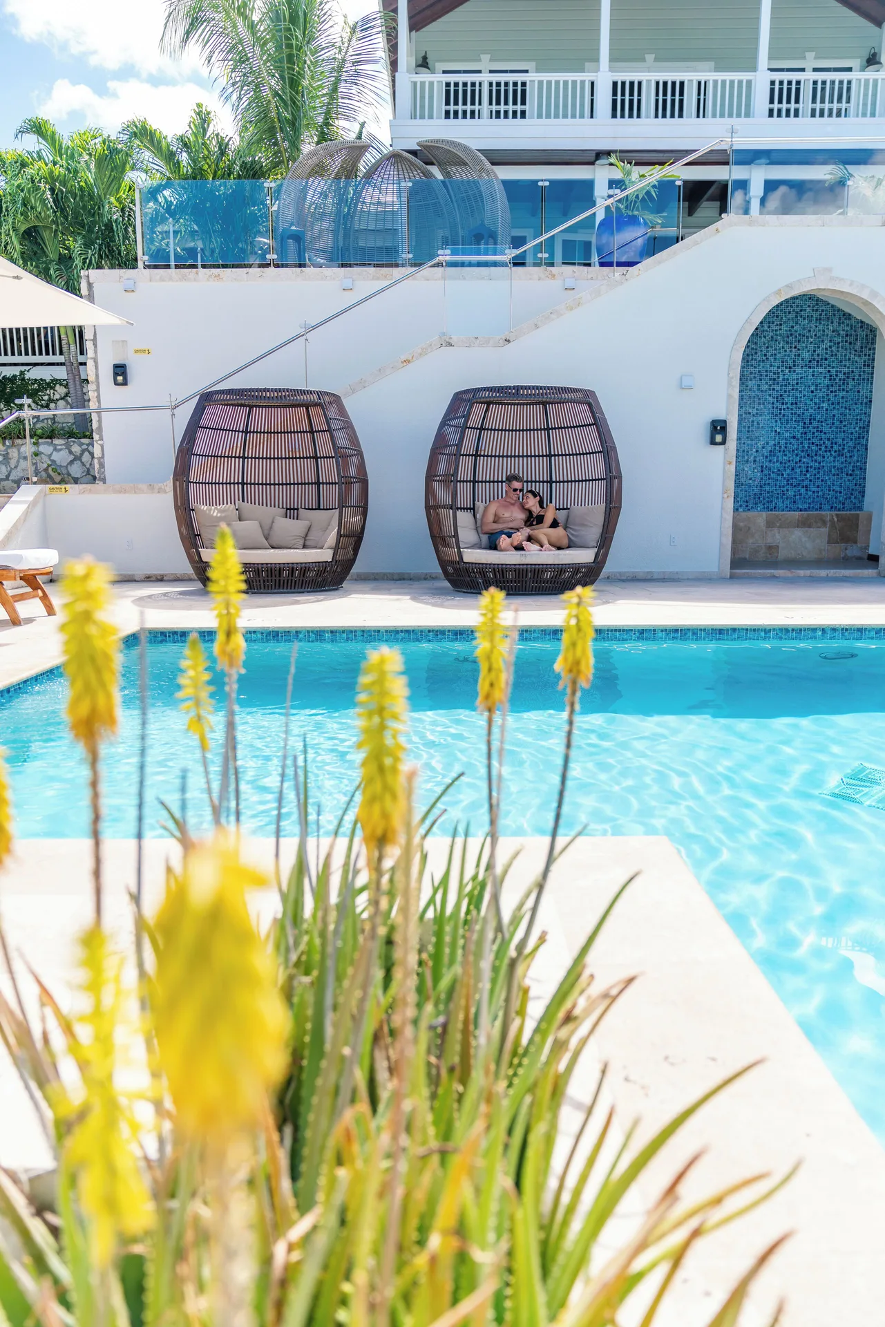 Poolside cabanas and flowering plants at Hammock Cove Antigua.