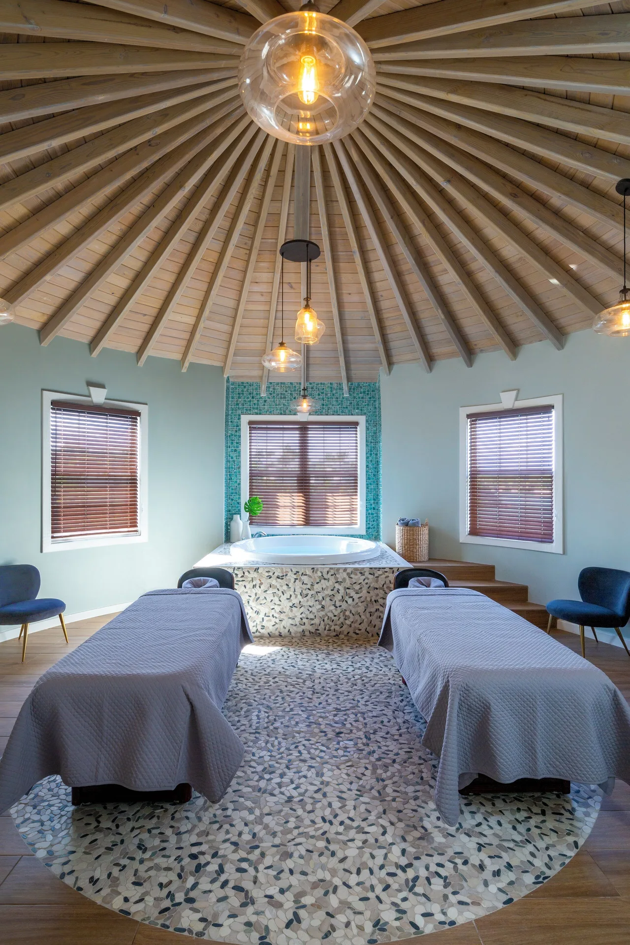 Dual spa treatment beds beneath a vaulted ceiling at Hammock Cove Antigua.