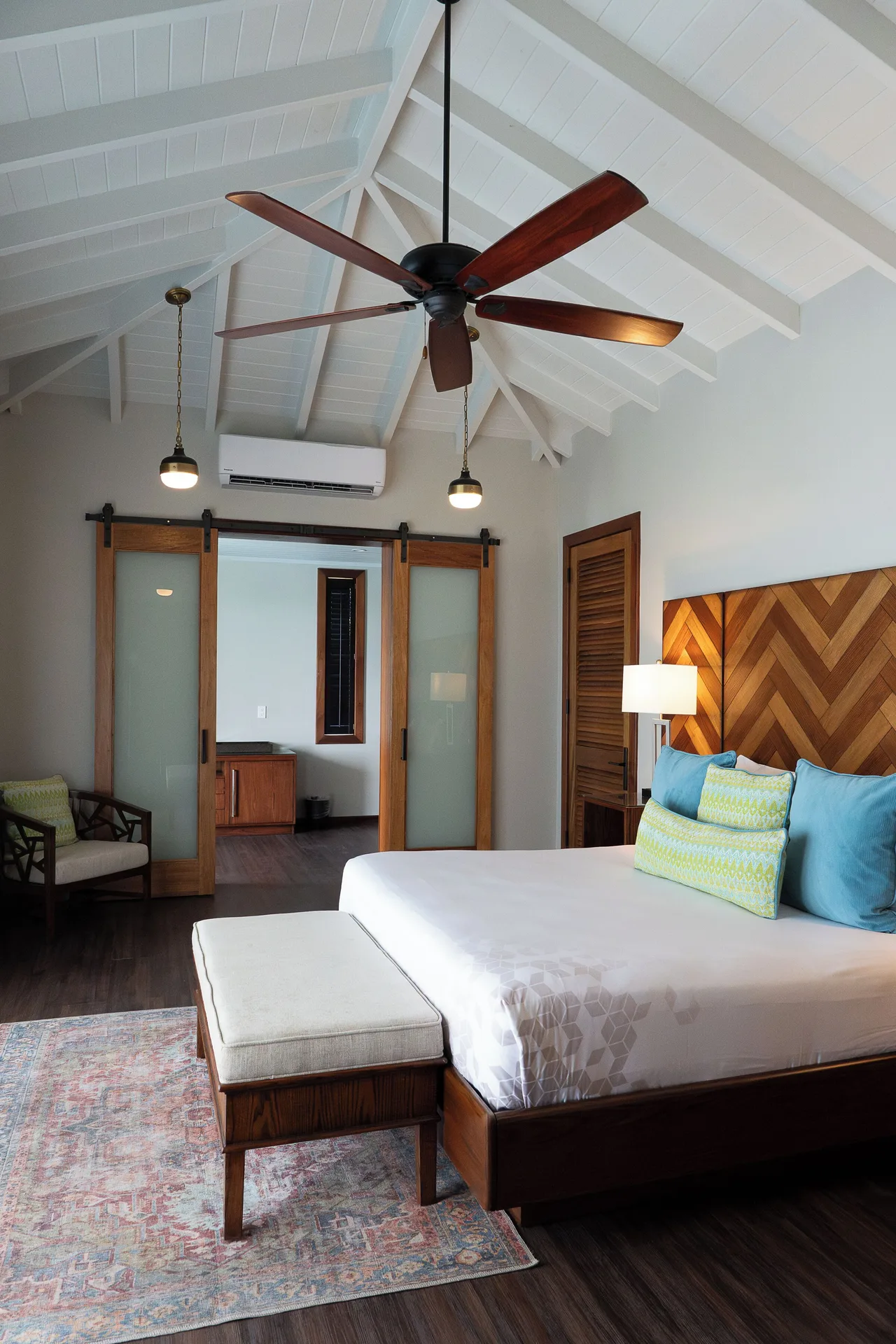 Signature Villa king bed with sliding doors and vaulted ceiling at Hammock Cove Antigua.