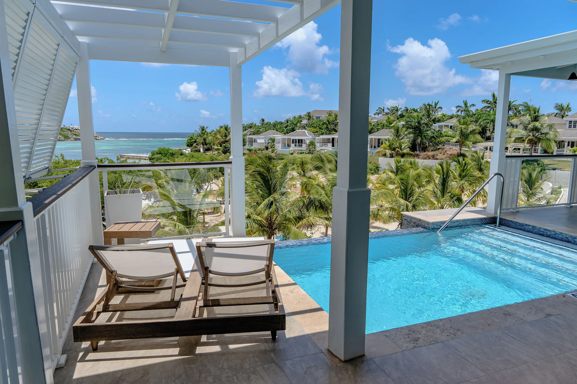Signature Villa private plunge pool and loungers with coastal view at Hammock Cove Antigua.