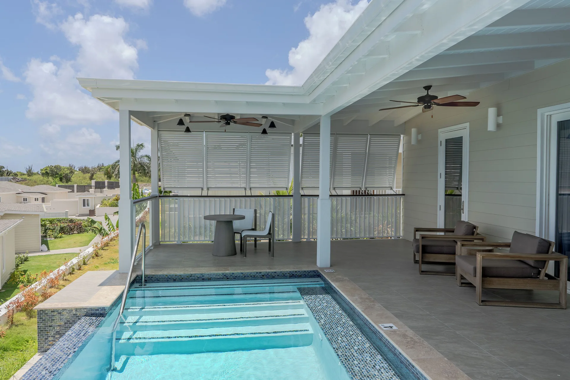 Signature Villa terrace with plunge pool, seating, and privacy shutters at Hammock Cove Antigua.