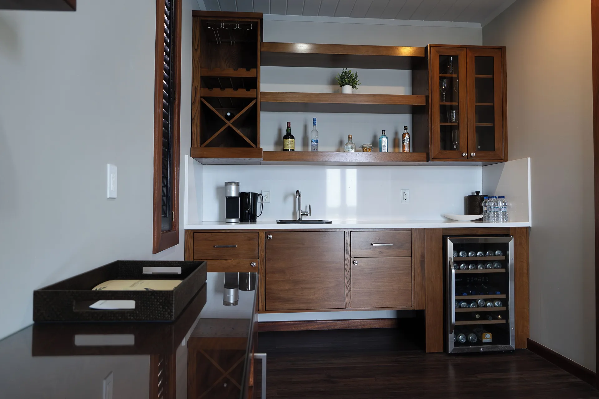 Signature Villa wet bar with sink, cabinets, and beverage cooler at Hammock Cove Antigua.