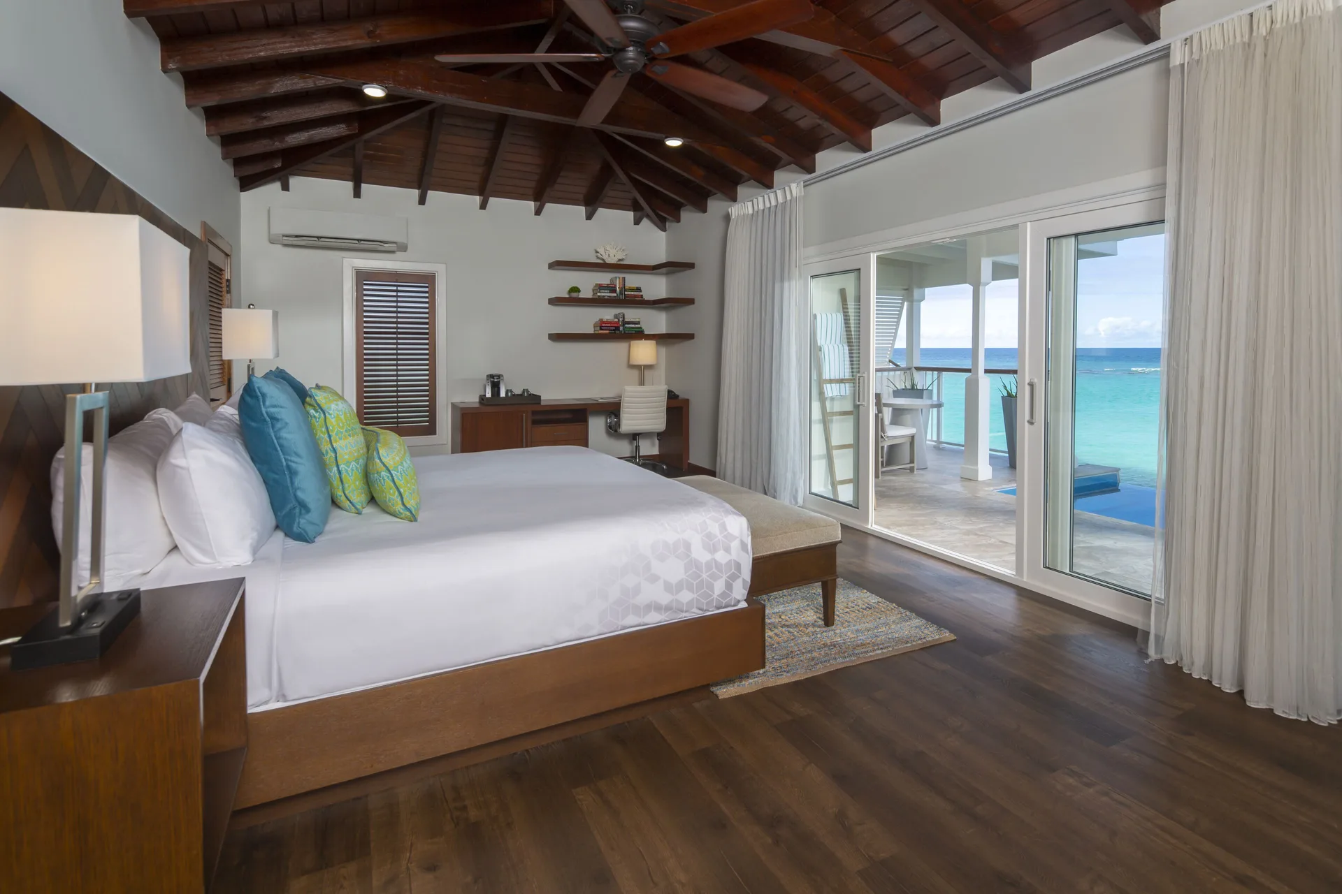 Waterfront Villa king bedroom with vaulted wood ceiling at Hammock Cove Antigua.