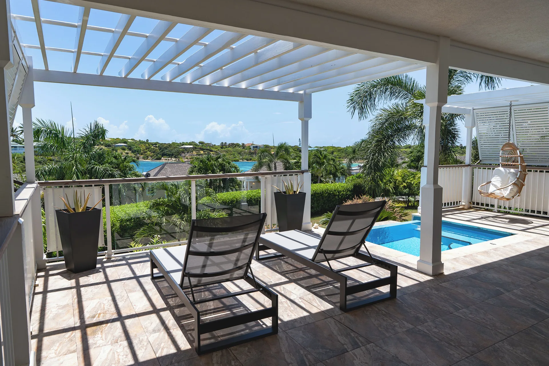 Waterview Villa terrace with loungers, plunge pool and water views at Hammock Cove Antigua.