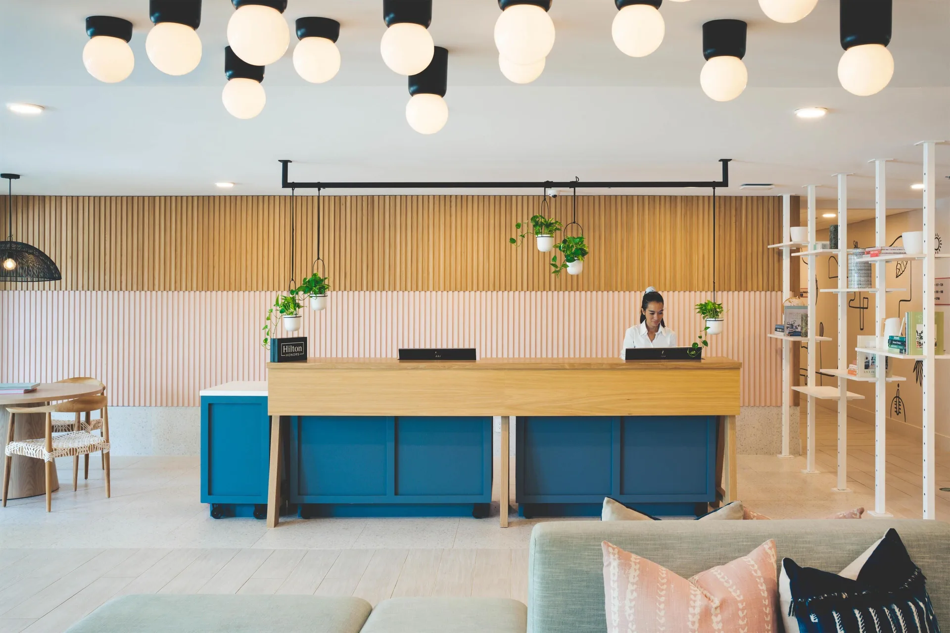 Front desk with staff member in the lobby at Hampton by Hilton Grand Cayman Seven Mile Beach.