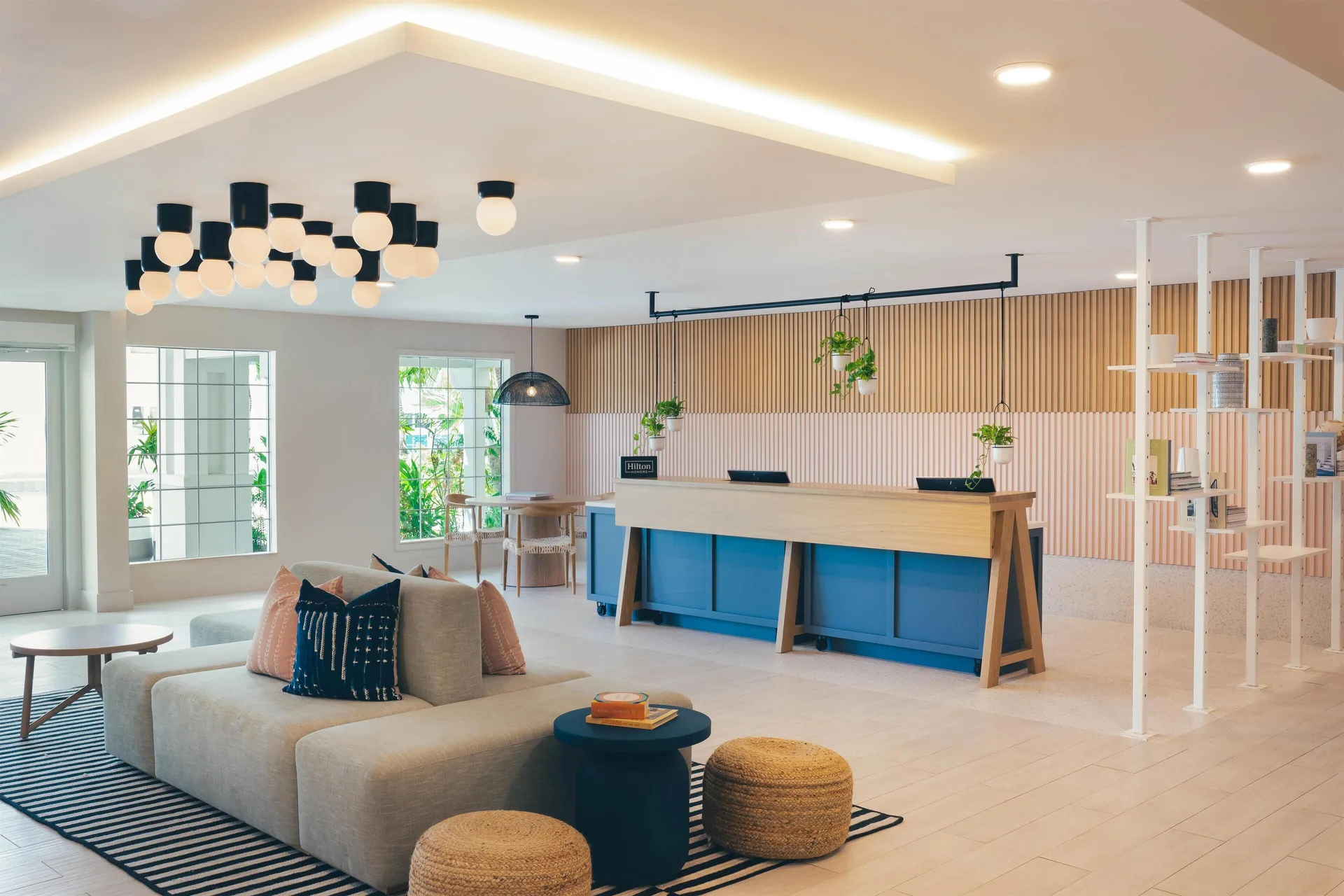 Lobby seating and front desk at Hampton by Hilton Grand Cayman Seven Mile Beach.