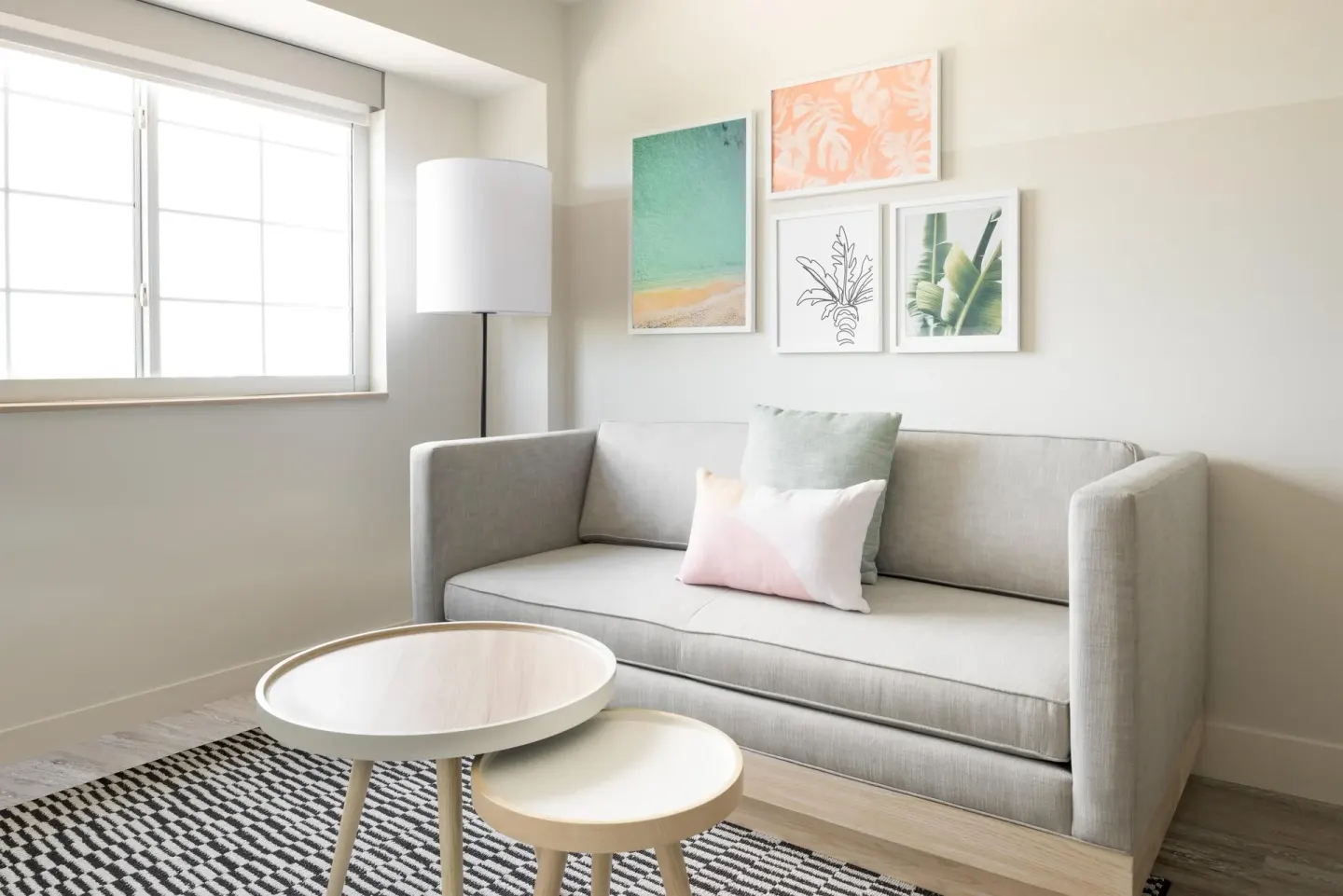 One Bedroom Suite sitting area with sofa at Hampton by Hilton Grand Cayman Seven Mile Beach.
