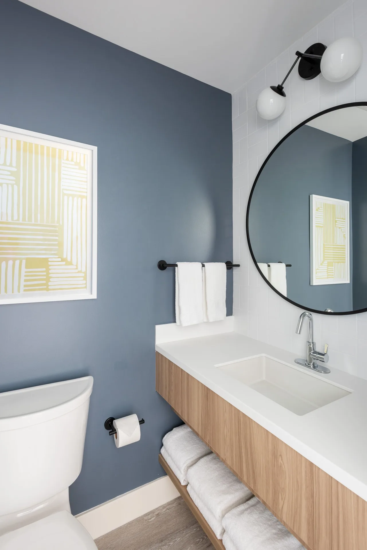 Standard room bathroom vanity and toilet at Hampton by Hilton Grand Cayman Seven Mile Beach.