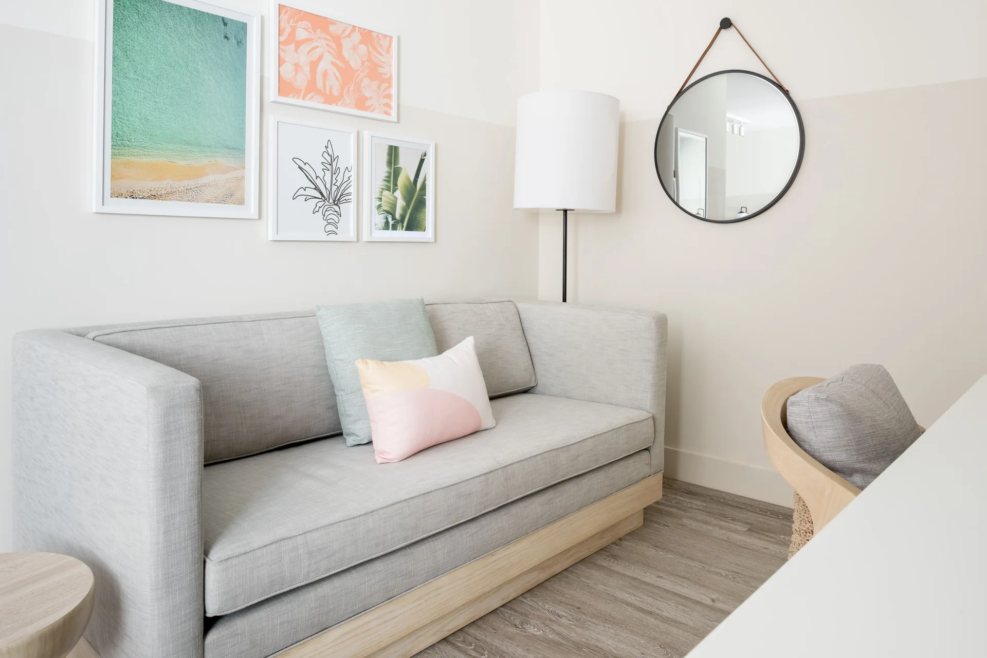Sofa seating area with wall art in an accessible studio at Hampton by Hilton Grand Cayman Seven Mile Beach.