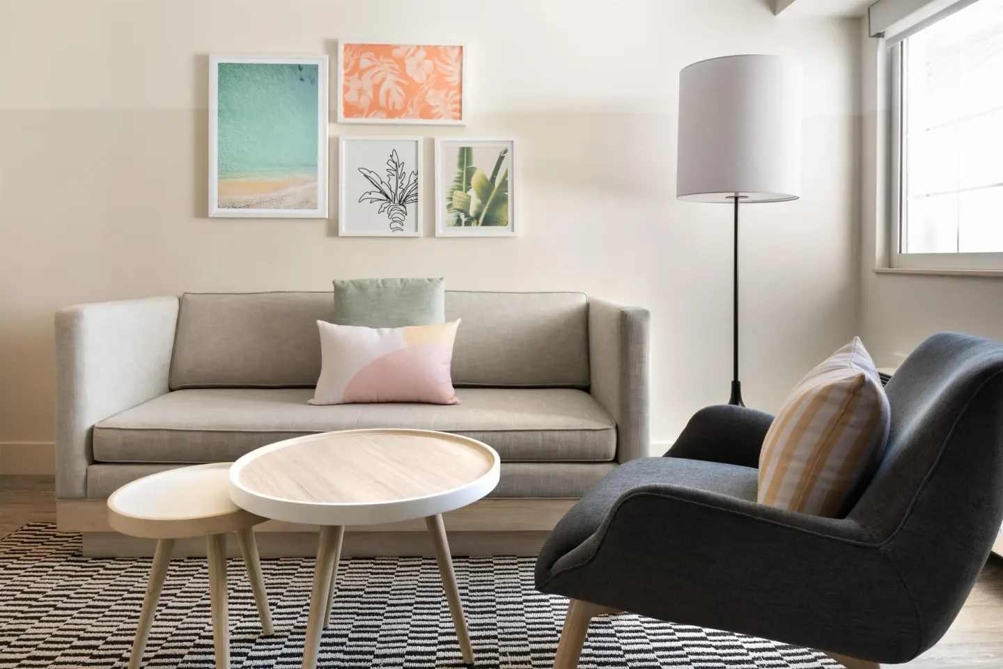 Studio lounge with sofa, chair, and coffee tables at Hampton by Hilton Grand Cayman Seven Mile Beach.