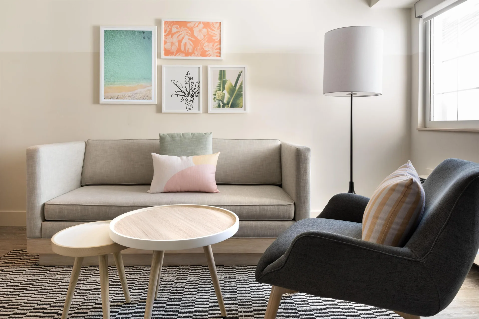 Studio lounge with sofa, chair, and coffee tables at Hampton by Hilton Grand Cayman Seven Mile Beach.
