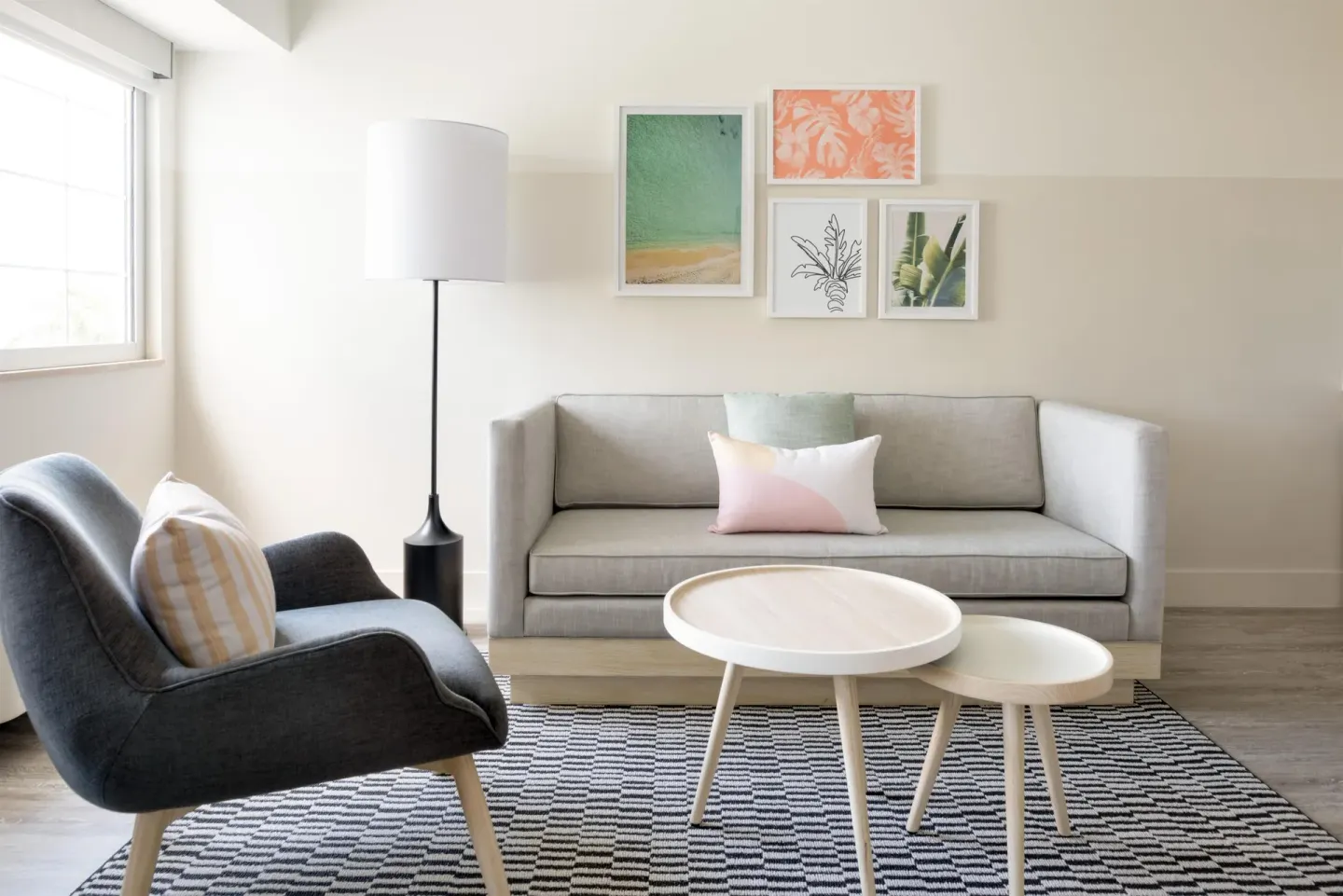 Studio sitting area with sofa and lounge chair at Hampton by Hilton Grand Cayman Seven Mile Beach.