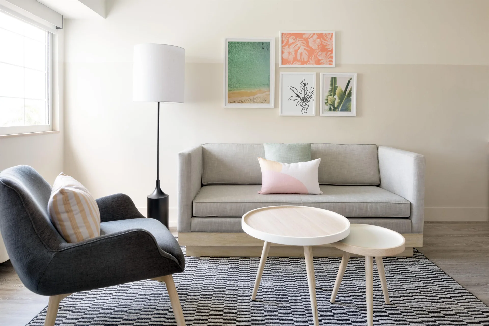 Studio sitting area with sofa and lounge chair at Hampton by Hilton Grand Cayman Seven Mile Beach.