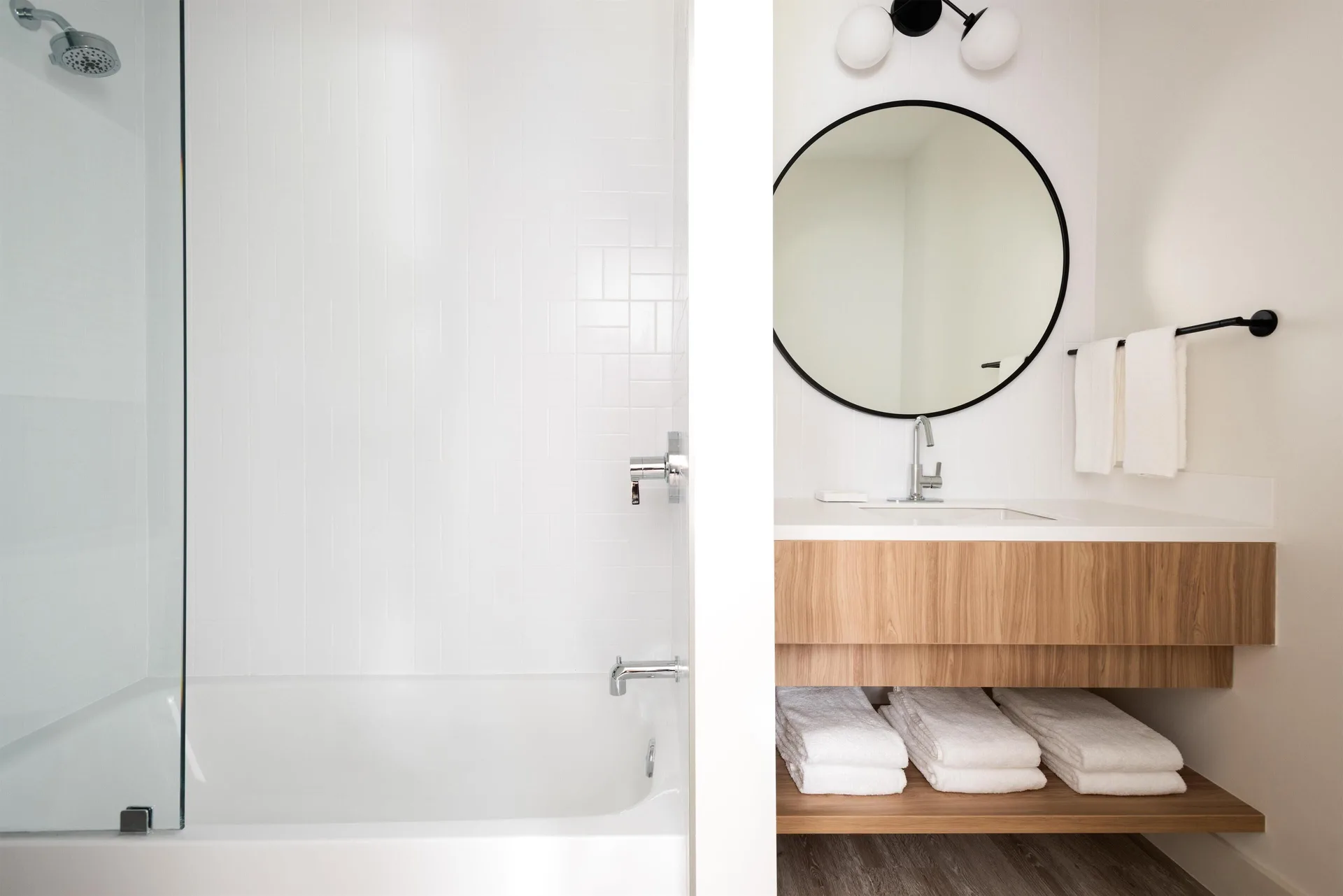 Two-bedroom suite bathroom vanity and tub at Hampton by Hilton Grand Cayman Seven Mile Beach.