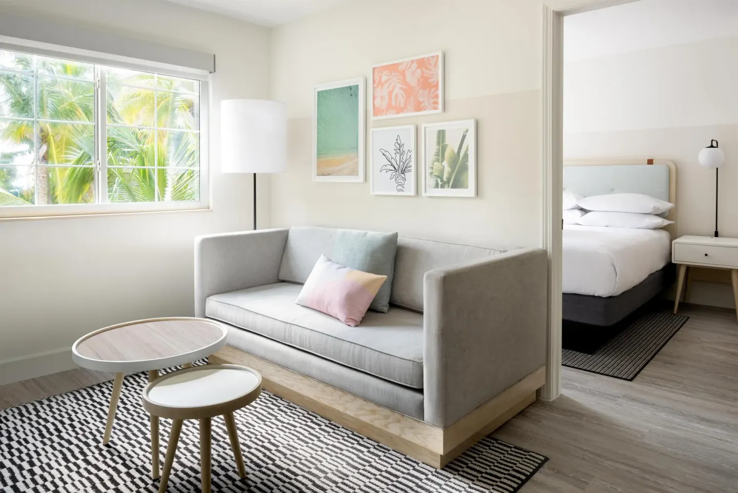 Two-bedroom suite living area and bedroom at Hampton by Hilton Grand Cayman Seven Mile Beach.