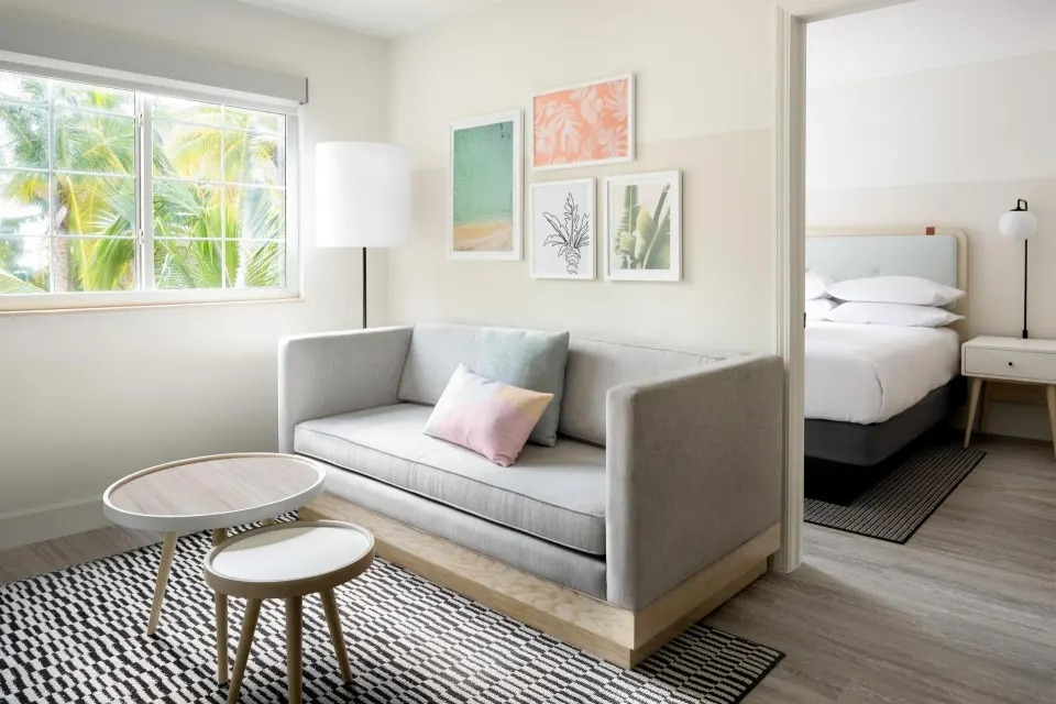 Two-bedroom suite living area and bedroom at Hampton by Hilton Grand Cayman Seven Mile Beach.