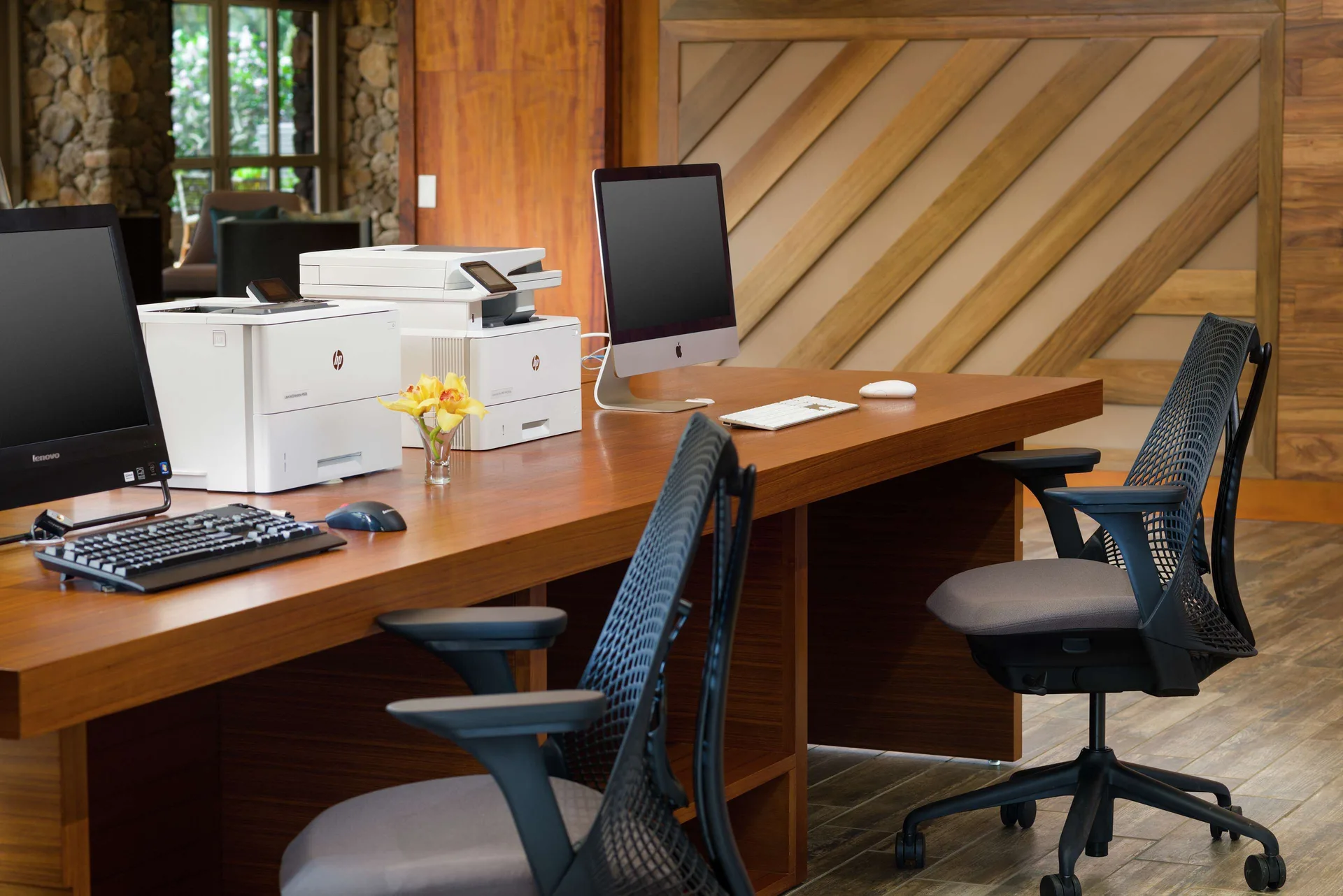 Business center desks with computers and printer at Hilton Garden Inn Kauai Wailua Bay.