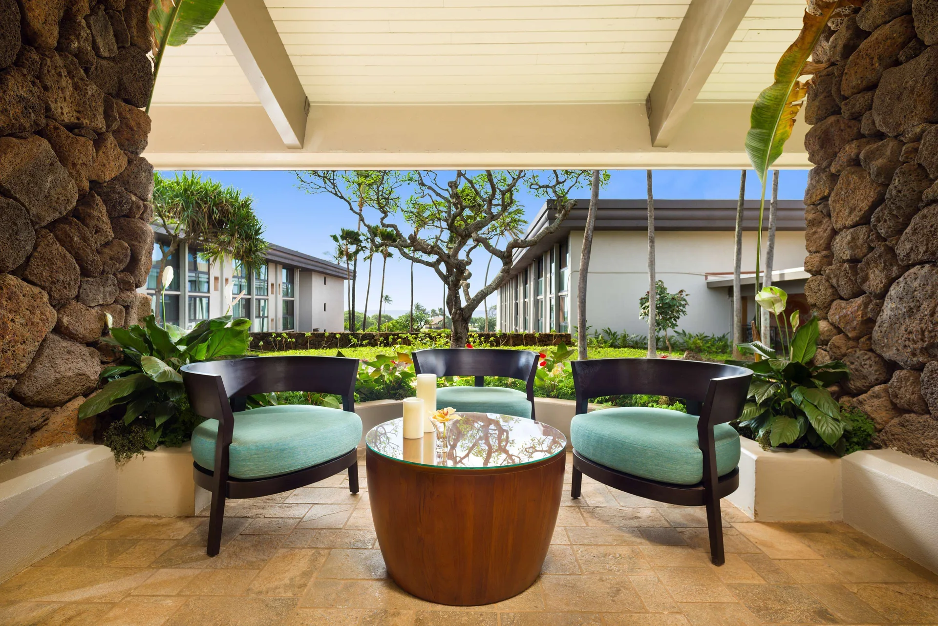 Garden-view seating nook with three chairs at Hilton Garden Inn Kauai Wailua Bay.