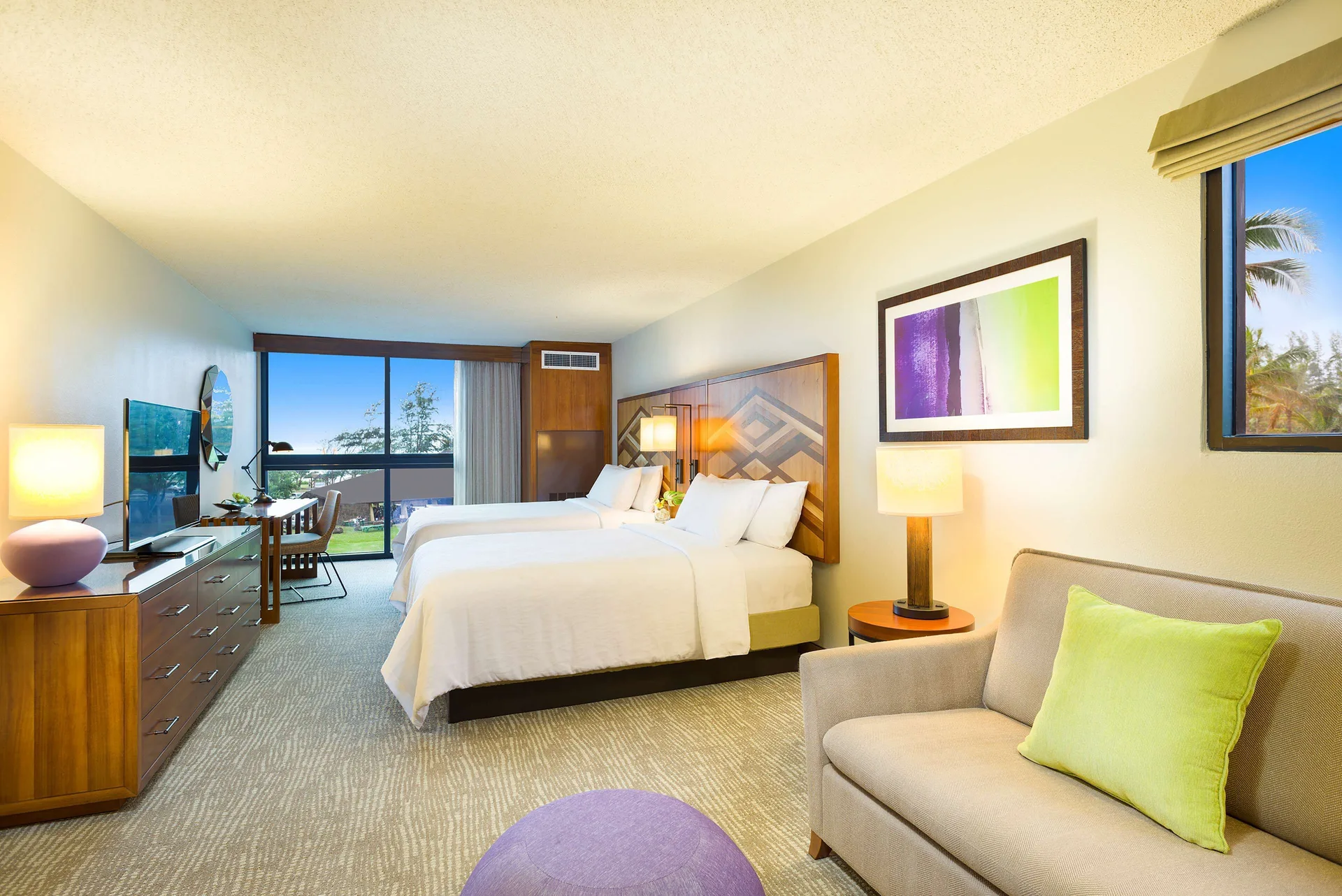 Guest room with two beds and sitting area at Hilton Garden Inn Kauai Wailua Bay.