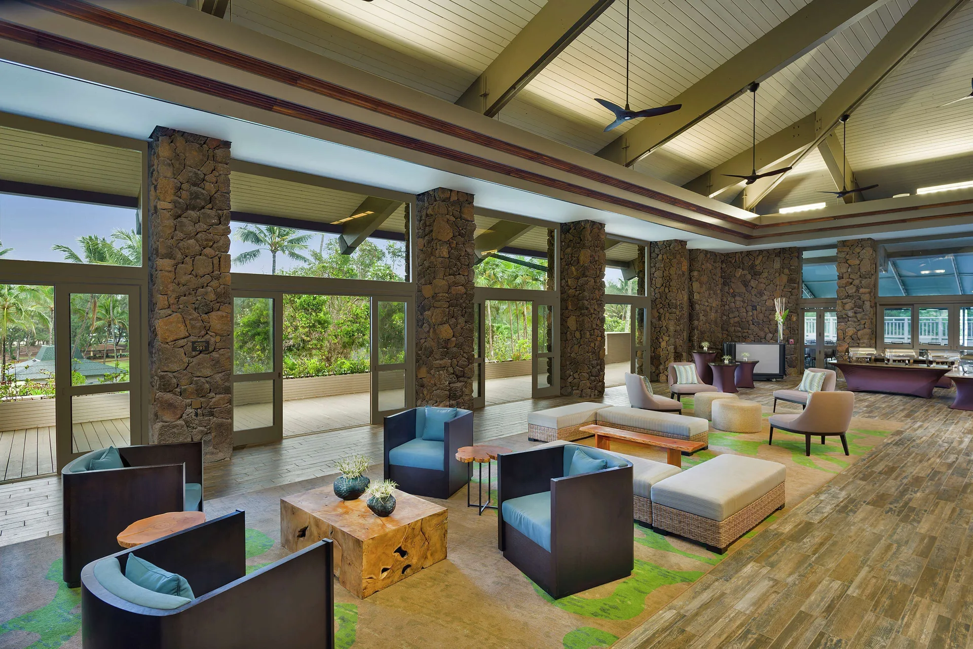 Spacious lobby seating with stone columns at Hilton Garden Inn Kauai Wailua Bay.