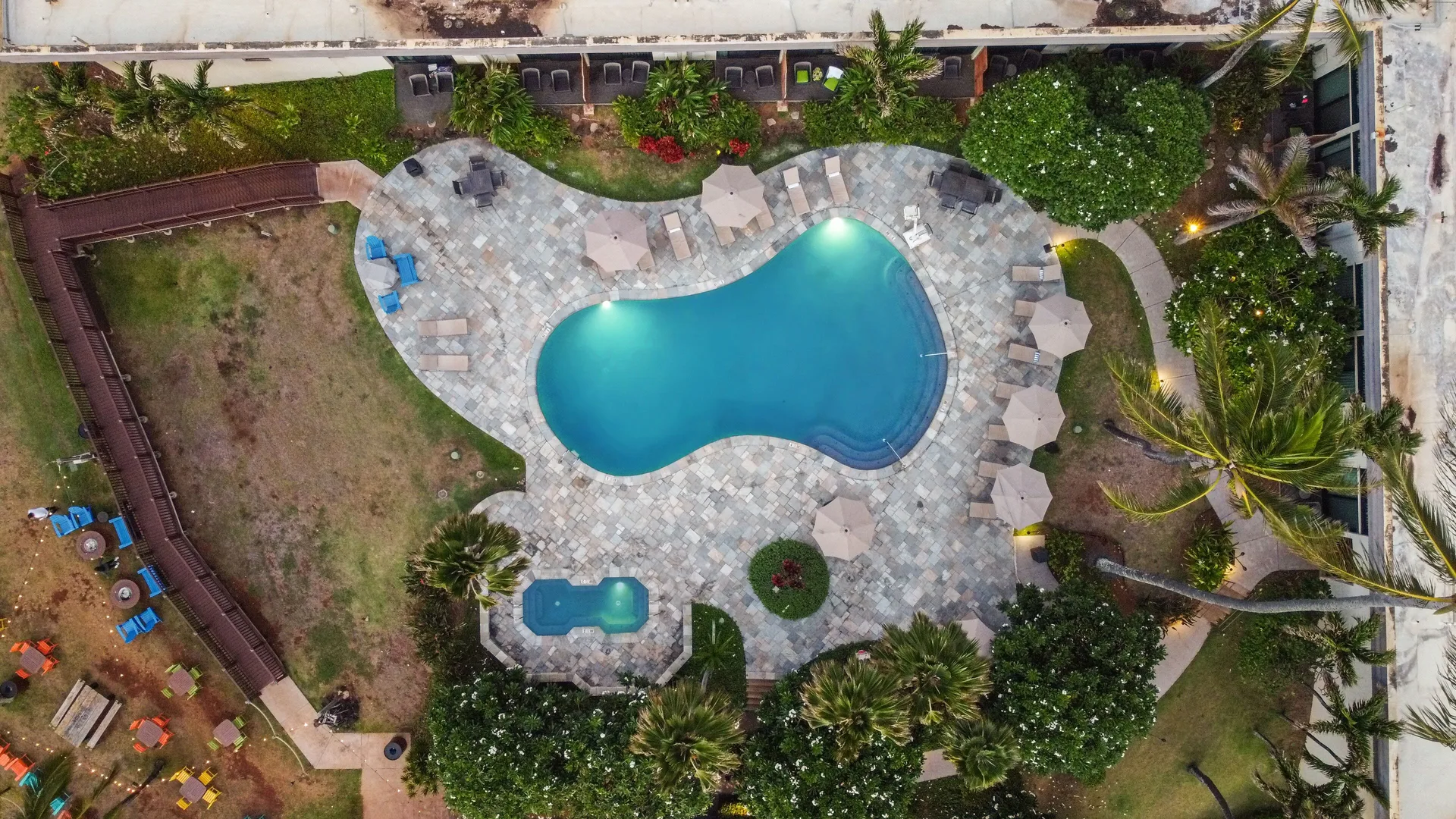 Aerial view of the pool deck and lounge chairs at Hilton Garden Inn Kauai Wailua Bay.
