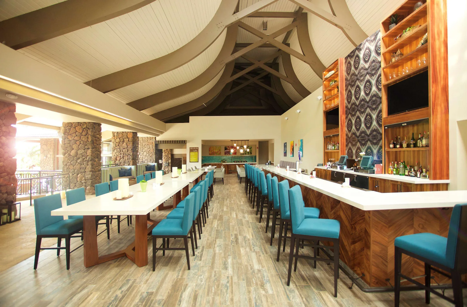 Restaurant and bar seating with high tables at Hilton Garden Inn Kauai Wailua Bay.