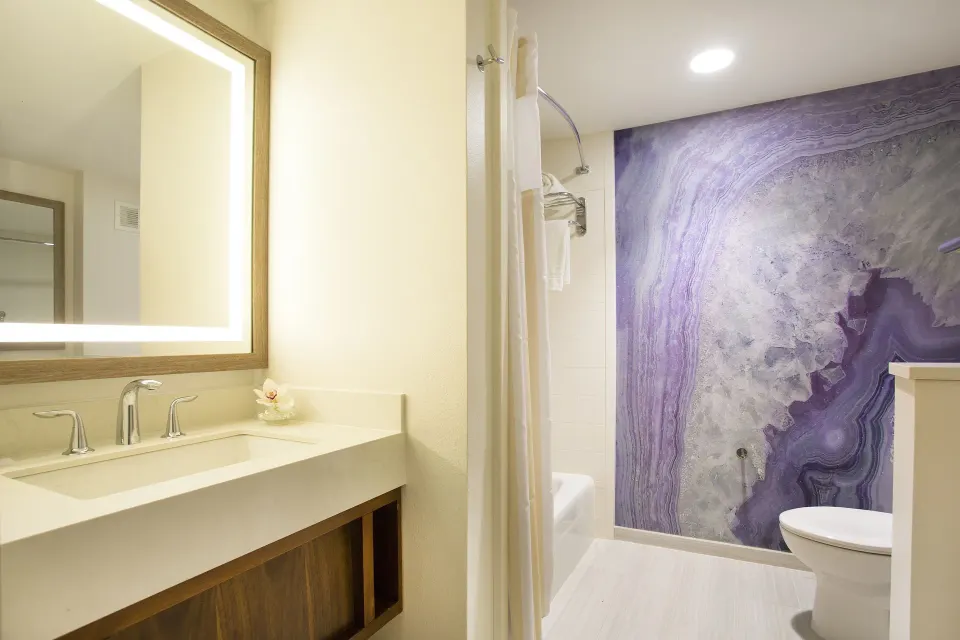 Junior Suite Ocean View bathroom vanity and shower at Hilton Garden Inn Kauai Wailua Bay.