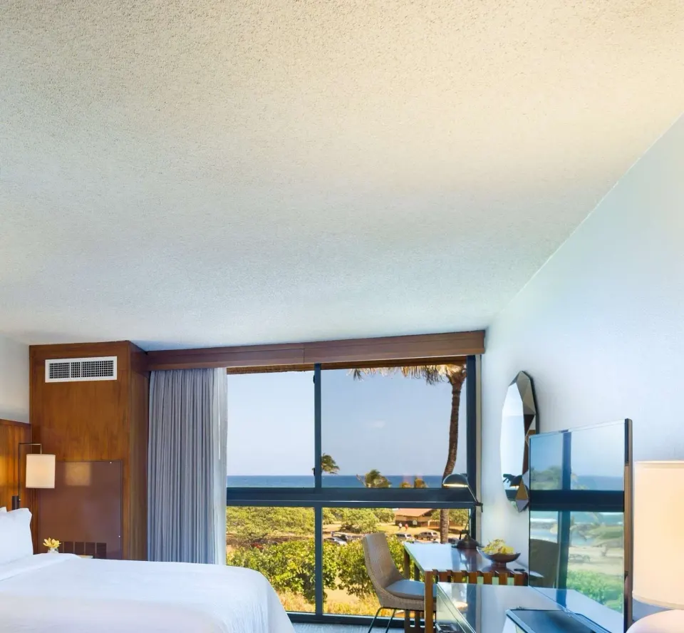 Junior Suite Ocean View bed and window view at Hilton Garden Inn Kauai Wailua Bay.