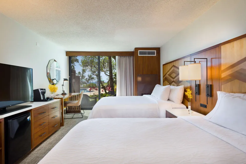 Accessible room with two beds and sliding glass door at Hilton Garden Inn Kauai Wailua Bay.